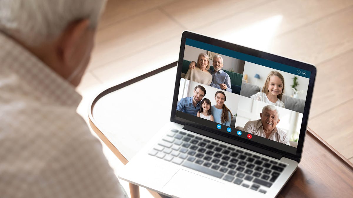 Elderly grandfather talk on video call with family from home